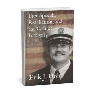 Erik J. Holt’s book Free Speech, Retaliation, and the Cost of Integrity displayed on a desk with a notebook and pencil.